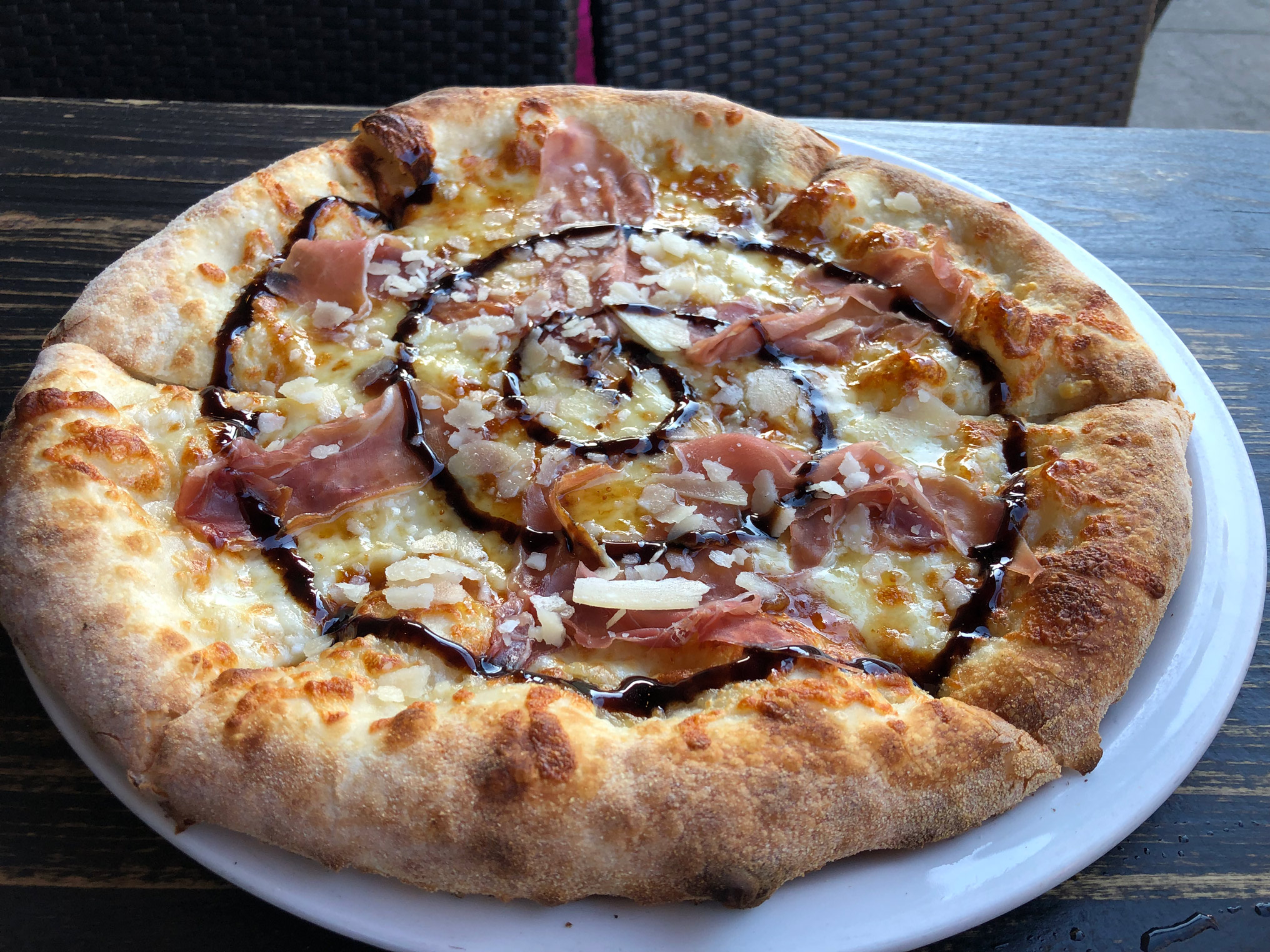 Top-down view of the full pizza, from at the restaurant.